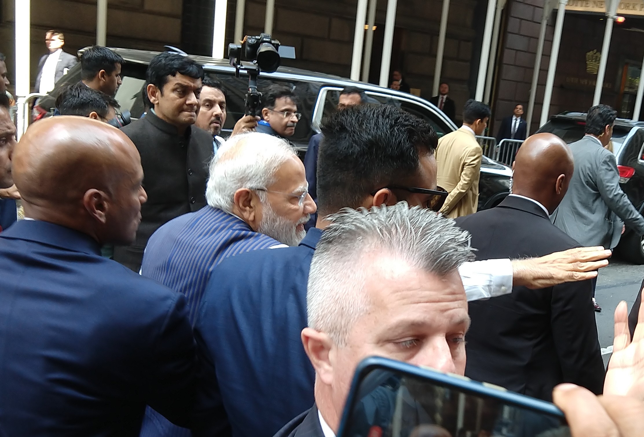 Prime Minister Narendra Modi greets supporters outside his hotel in New York on Tuesday, June 20, 2023 as worried Secret Service agents and other security personnel hem him in as he flouts security measures. (Photo: Arul Louis)