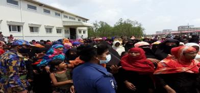 Rohingya refugees gather in an area of a complex housing at Bhashan Char in Bangladesh during a visit by senior officials of the United Nations refugee agency (UNHCR), May 31, 2021. (Source: BenarNews) Rohingya refugees gather in an area of a complex housing at Bhashan Char in Bangladesh during a visit by senior officials of the United Nations refugee agency (UNHCR), May 31, 2021. (Source: BenarNews)