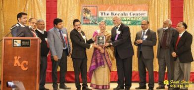 ACP President Dr. George Abraham receiving award from Indian Consul A.K. Vijayakrishnan. From l. to r. Kimmy John, Dr. Thomas Abraham, James Thottam, Dr. Madhu Bhaskaran, Consul Vijayakrishnan, Dr. Susan George, Dr. George Abraham, Alex Esthappan, Thambi Thalappillil and John Paul