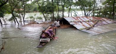 A family flees a flood-affected area by boat in Sylhet, Bangladesh, June 2022. This year’s flooding has been worsened by unusual wind patterns linked to climate change, experts say (Image: Alamy) A family flees a flood-affected area by boat in Sylhet, Bangladesh, June 2022. This year’s flooding has been worsened by unusual wind patterns linked to climate change, experts say (Image: Alamy)