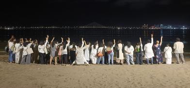 Mumbai peace walkers stand in solidarity at a beach in Central Mumbai.